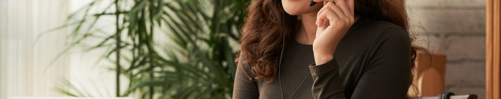 Smiling business woman in headset consuting clients